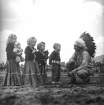 Image of Native American man with four anglo children dressed in Native American costumes