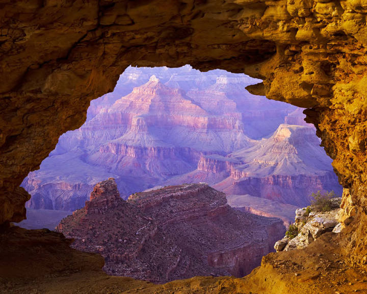 This image shows rock formations in the Grand Canyon through a hole in a limestone rock at the South Rim.