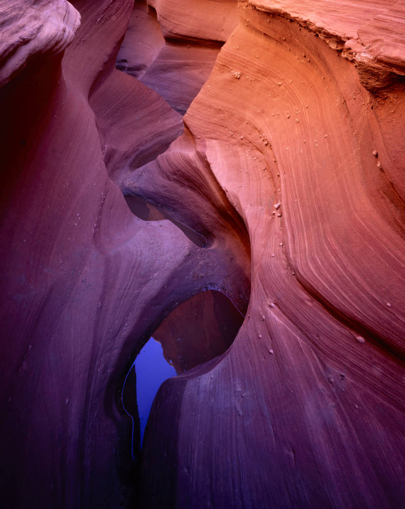 Image depicts a slot canyon in Page, Arizona (from website) with a rainpool on the bottom half of the image