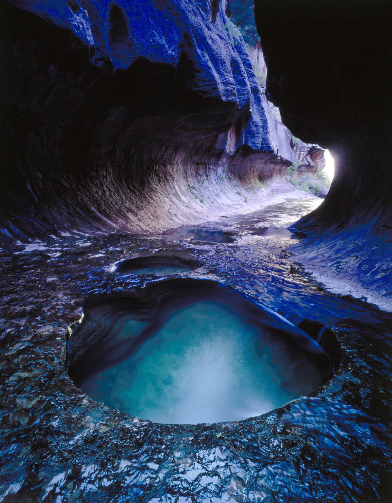 Image depicts the Subway or Left Fork slot canyon in Zion National Park with pools of water